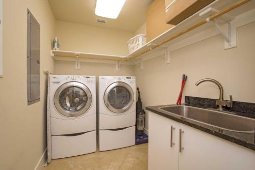 a laundry room with a sink and a washing machine at Turquoise Place C2202 in Orange Beach