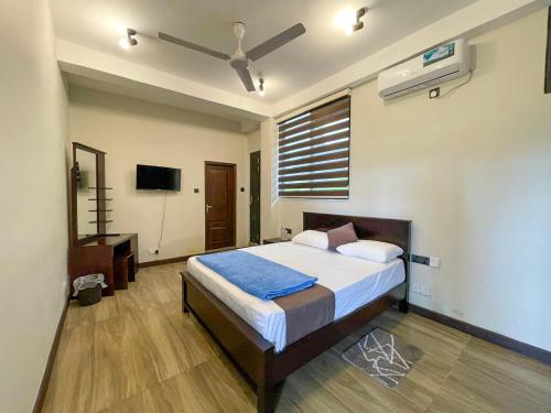 a bedroom with a bed and a ceiling fan at Lush Breeze in Kandy