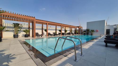 a swimming pool on the roof of a building at Deluxe Studio - Stylish & Cosy in Luma22 in Dubai