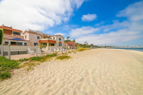 a beach with chairs and houses and the ocean at On The Beach Casita in San Diego