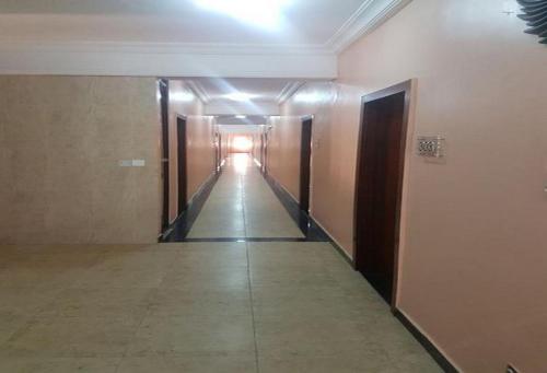 a hallway of a building with a light at the end at Cynergy Suites Royale - Standard in Lagos