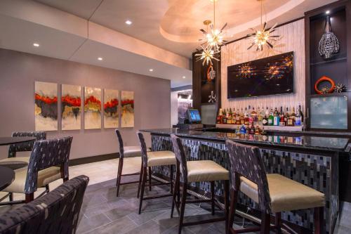 a bar in a restaurant with chairs and tables at Fairfield Inn & Suites by Marriott Boston Cambridge in Cambridge