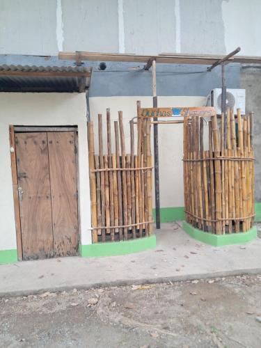 a group of bamboo poles in front of a building at Hinterland Camping RV Park in Las Peñitas
