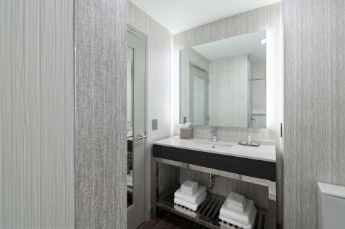 a bathroom with a sink and a mirror at Fairfield by Marriott Inn & Suites Boston Medford in Medford