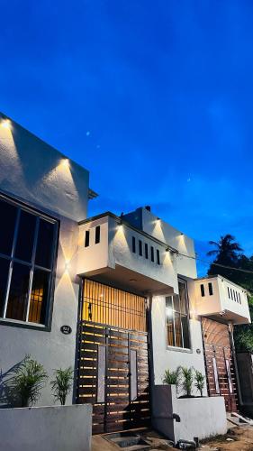 a house with lights on the front of it at THE ELEGANT VILLA WITH KITCHEN, Opp to Mangrove Boating - JR Groups in Puducherry