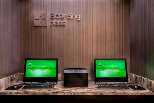 two laptops sitting on a counter in a room at Courtyard by Marriott Bethesda Chevy Chase in Bethesda