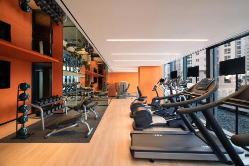 a gym with treadmills and elliptical machines at Courtyard by Marriott Suwon in Suwon