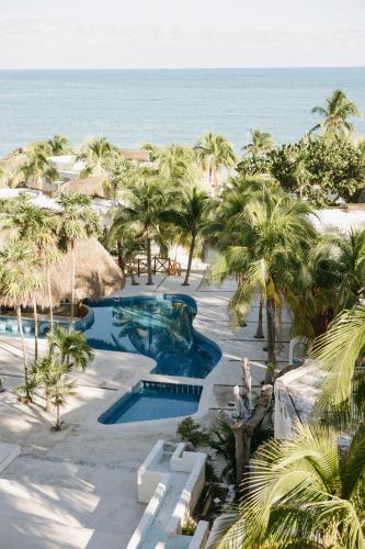 an aerial view of a resort with a pool and the ocean at Elysian Private Haven Ultimate Front Beach Paradise, Isla Blanca in Isla Blanca