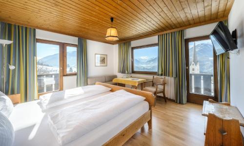 a hotel room with a large bed and a large window at Bärenwirth in Innsbruck