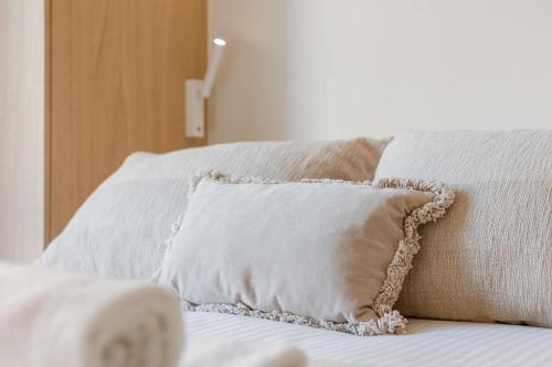 a white pillow sitting on top of a bed at Huswell - Luxury apartment with parking in Knokke in Knokke-Heist