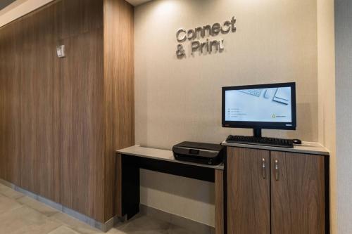 a room with a computer on a counter with a wall at Fairfield Inn & Suites by Marriott Brownsville North in Brownsville