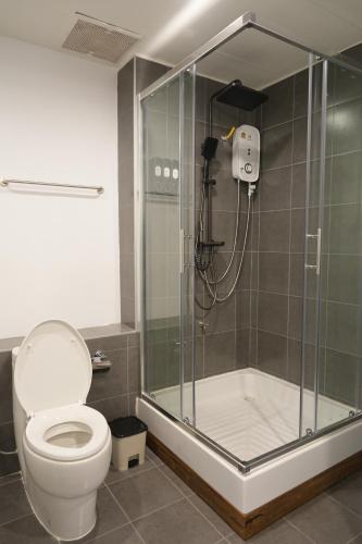 a bathroom with a shower and a toilet at maross bed and room in Chiang Mai