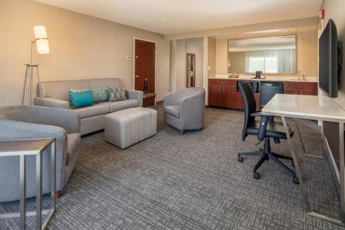 a living room with a couch and a table at Courtyard Seattle Sea-Tac Area in Tukwila