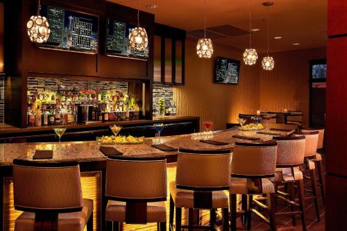 a bar with a long table and chairs at Courtyard Seattle Sea-Tac Area in Tukwila