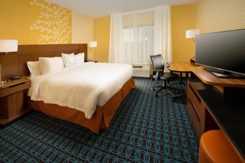 a hotel room with a bed and a flat screen tv at Fairfield Inn & Suites by Marriott Arundel Mills BWI Airport in Hanover