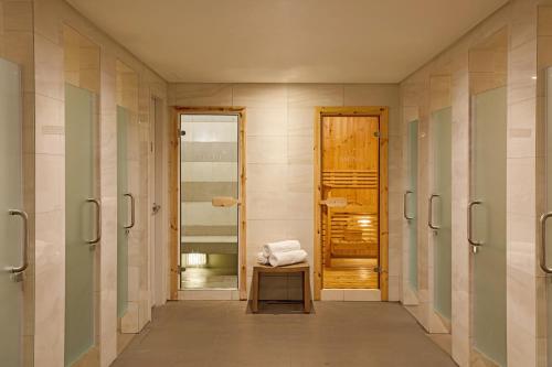 a bathroom with a walk in shower with a bench at Grand Westside Manila Bay in Manila