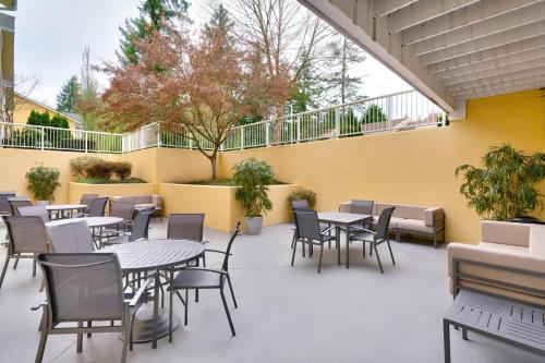 a patio with tables and chairs and a yellow wall at Fairfield Inn & Suites Seattle Bellevue/Redmond in Bellevue