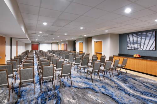 a conference room with chairs and a stage in the middle at Fairfield Inn & Suites Seattle Bellevue/Redmond in Bellevue