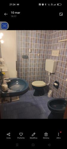 a bathroom with a tub and a toilet and a sink at Esperia in Caorle