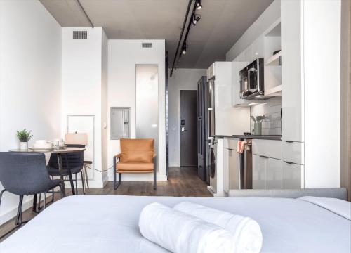 a bedroom with a bed and a table and chairs at Monthier The Wharf BLW9S5U7-2 in Washington, D.C.
