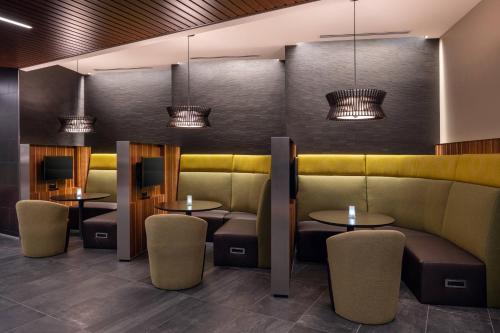 a restaurant with tables and chairs and lights at Courtyard by Marriott Petaluma Sonoma County in Petaluma