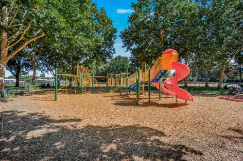 a playground with a slide in a park at 495 - Upscale Home with AC and Patio near Meta and Stanford in Menlo Park