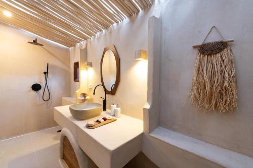 a bathroom with a sink and a mirror at TANPURI Watket - 8-Bedrooms Villa with Private Pool in the Old Town City - PRIME LOCATION in Chiang Mai
