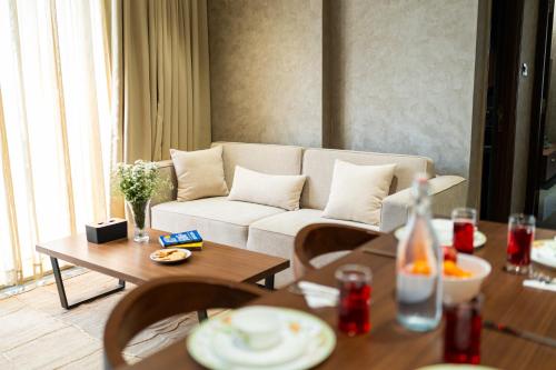 a living room with a couch and a table at Brisa by StayALYF in Candolim