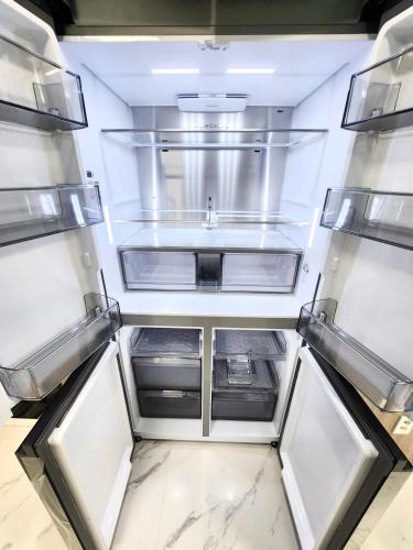 an empty refrigerator with a sink in the middle at Majestic Seoul Stay Central in Seoul