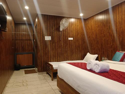 a bedroom with two beds with towels on them at Sky Elanza in Munnar