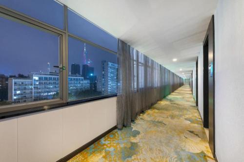 a corridor of an office with a view of a city at Movie Star Hotel in Guangzhou