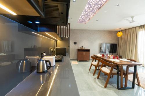 a kitchen with a table and chairs in a room at Brisa by StayALYF in Candolim