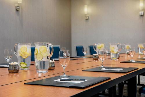 a long wooden table with glasses of water and lemons at Courtyard by Marriott Edmonton West in Edmonton
