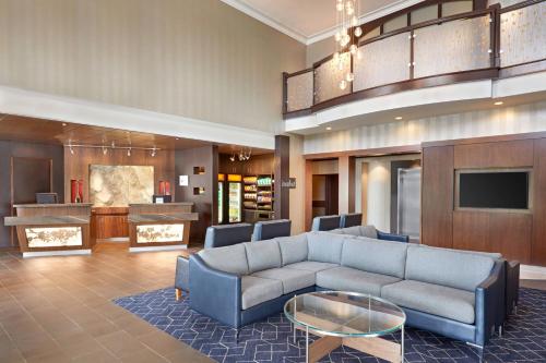 a living room with a couch and a table at Courtyard by Marriott Waterloo St. Jacobs in Waterloo