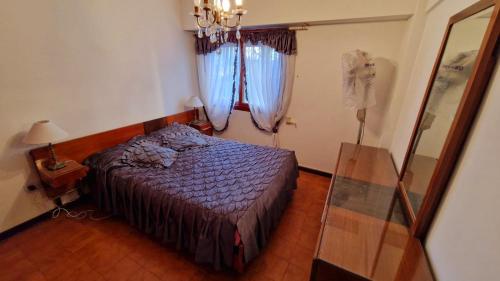 a bedroom with a bed and a mirror and a window at San Bernardo in San Bernardo