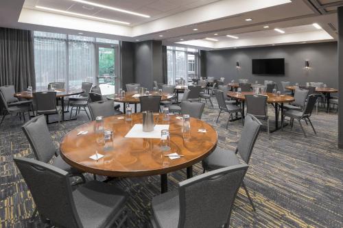 a conference room with tables and chairs and a screen at Courtyard by Marriott Halifax Dartmouth in Halifax