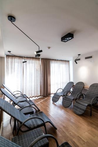 a group of chairs in a room with wooden floors at Hotel Polanica Resort & Spa in Polanica-Zdrój