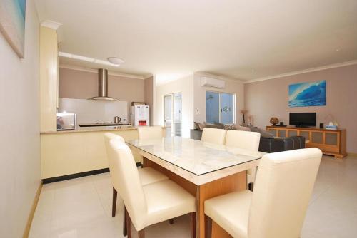 a dining room and kitchen with a table and chairs at Ocean Breeze in Jurien Bay