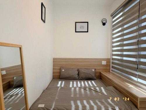 a bed in a room with a large window at Sunflower Garden Homestay Đà Lạt in Xuan An