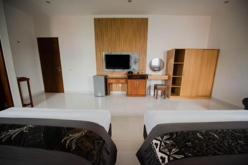 Ένα ή περισσότερα κρεβάτια σε δωμάτιο στο Sandat Hotel Legian
