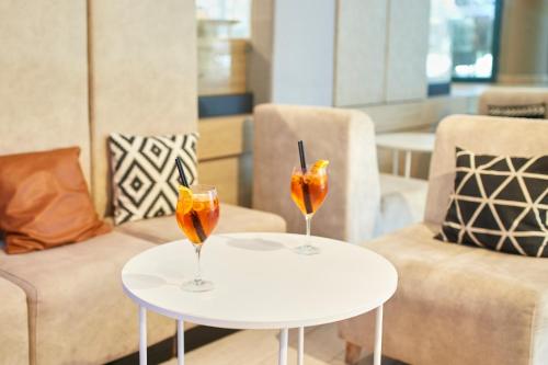 two drinks sitting on tables in a room at Hotel Marvel All Inclusive - FULLY RENOVATED FREE Beach Access in Sunny Beach
