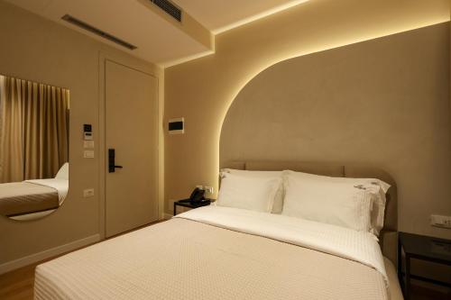 a bedroom with a white bed with an arch above it at Beratinus1 in Berat