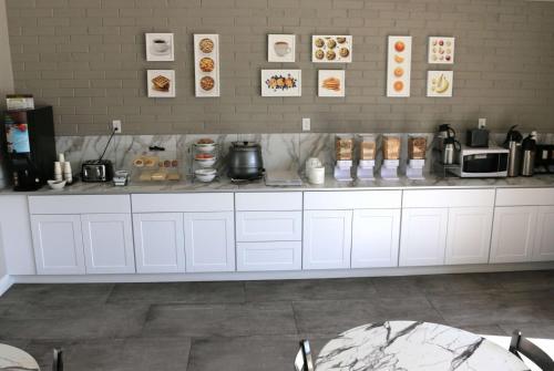 a kitchen with a counter with food on it at Ramada by Wyndham Richfield UT I-70 in Richfield