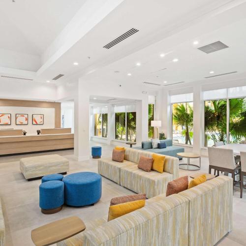 a living room with couches and chairs and a table at Hilton Garden Inn Ft. Lauderdale Airport-Cruise Port in Dania Beach