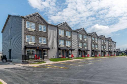 a row of apartment buildings in a parking lot at Quality Inn & Suites Amsterdam in Fredericton