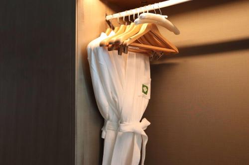 a closet with a white robe and a hanger at Wyndham Garden Jinjiang in Jinjiang