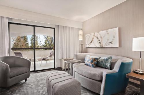 a living room with a couch and a chair at Courtyard by Marriott San Jose South/Morgan Hill in Morgan Hill