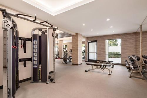 a gym with treadmills and machines in a room at Courtyard by Marriott San Jose South/Morgan Hill in Morgan Hill