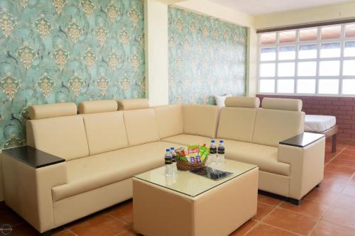 a living room with a couch and a table at Reunion Ocean Waves - Beach House in Udupi