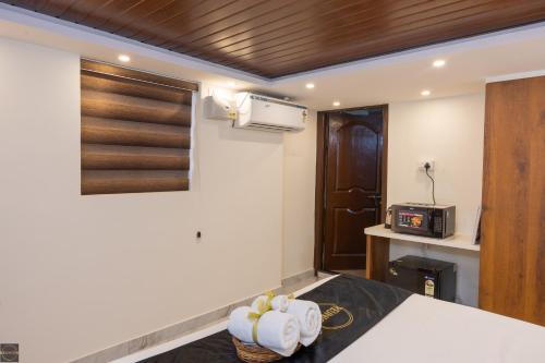 a room with a bed and a microwave on the wall at Reunion Ocean Waves - Beach House in Udupi